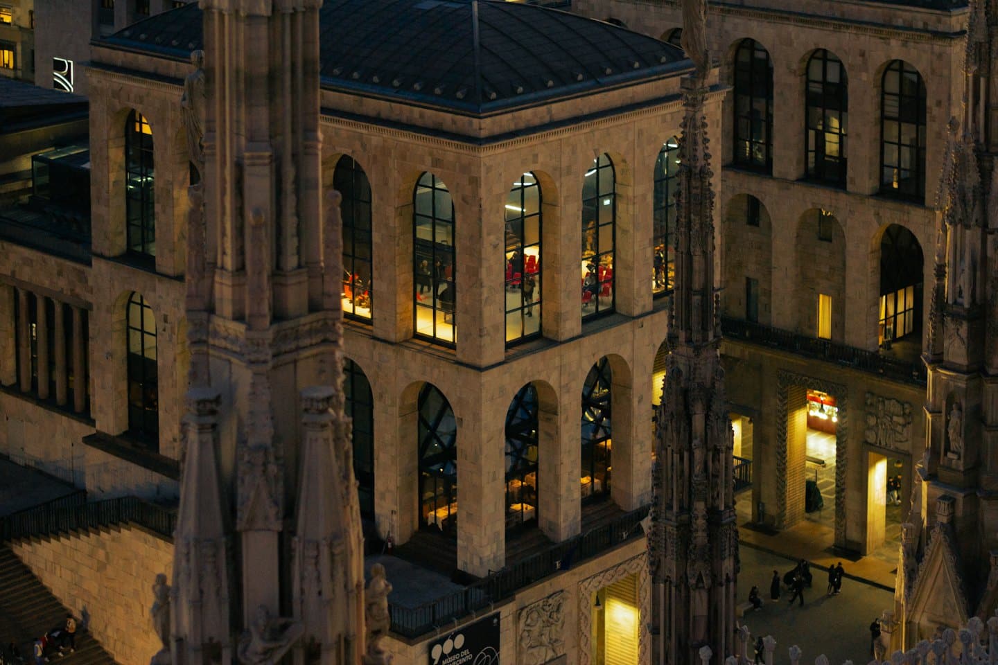 Aerial view of historic and modern buildings at dusk.
